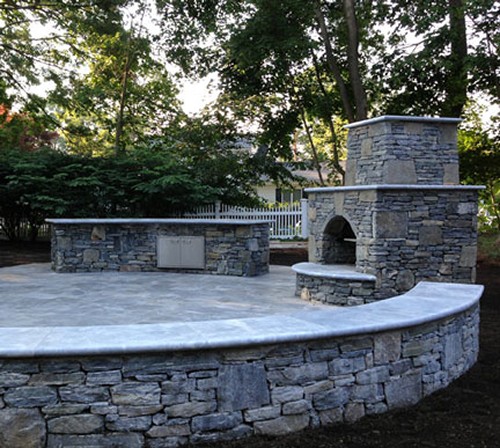 Fireplace with Arched Opening, Travertine Mantle and Sitting Wall Top by New View